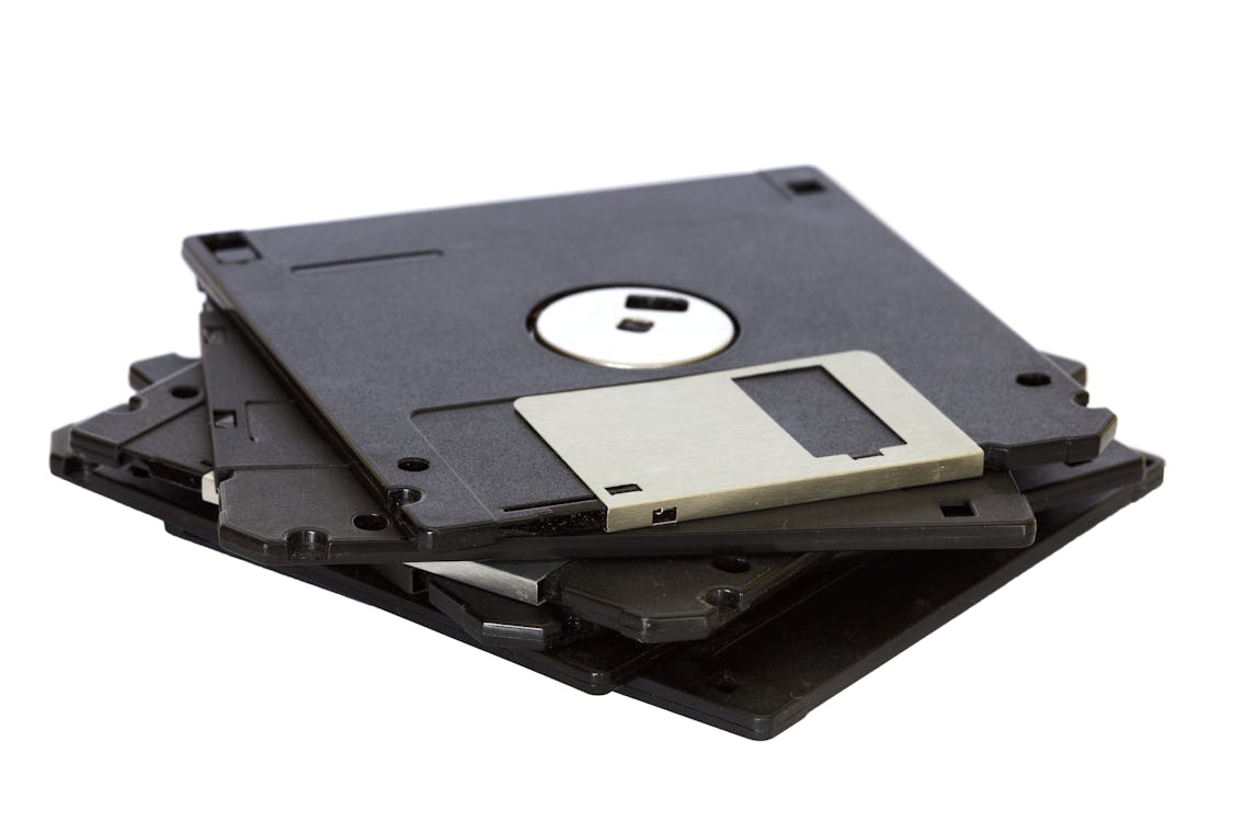 Four Black Floppy Discs on White Surface