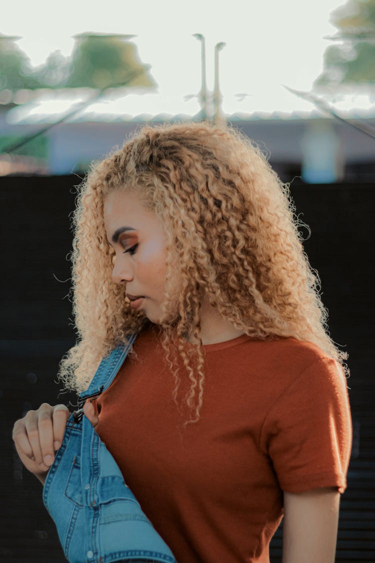 Woman Taking Off Denim Jumpsuit