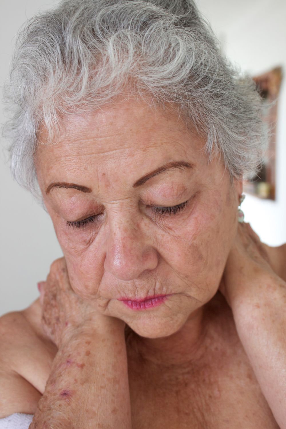 A serene elder with closed eyes, resting in quiet contemplation