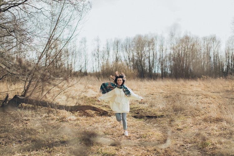 Happy Woman Running In Autumn Field