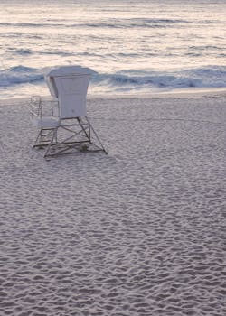 Serene scene of an empty lifeguard station on Bondi Beach with gentle ocean waves.