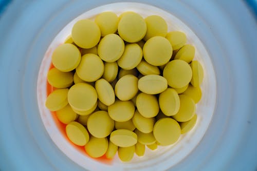 Jar of yellow pills from above