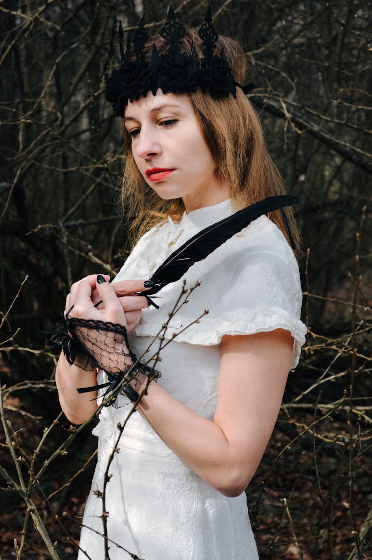 Melancholic Female With Raven Feather