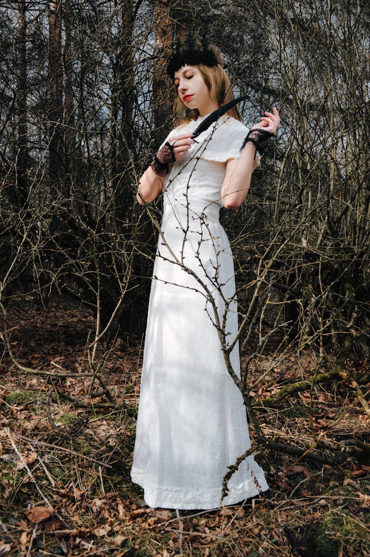 Gothic Lady In White Dress Standing In Forest