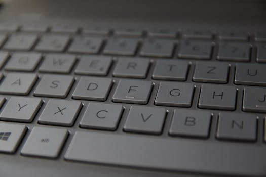 Detailed close-up of a sleek metallic German keyboard with QWERTZ layout.