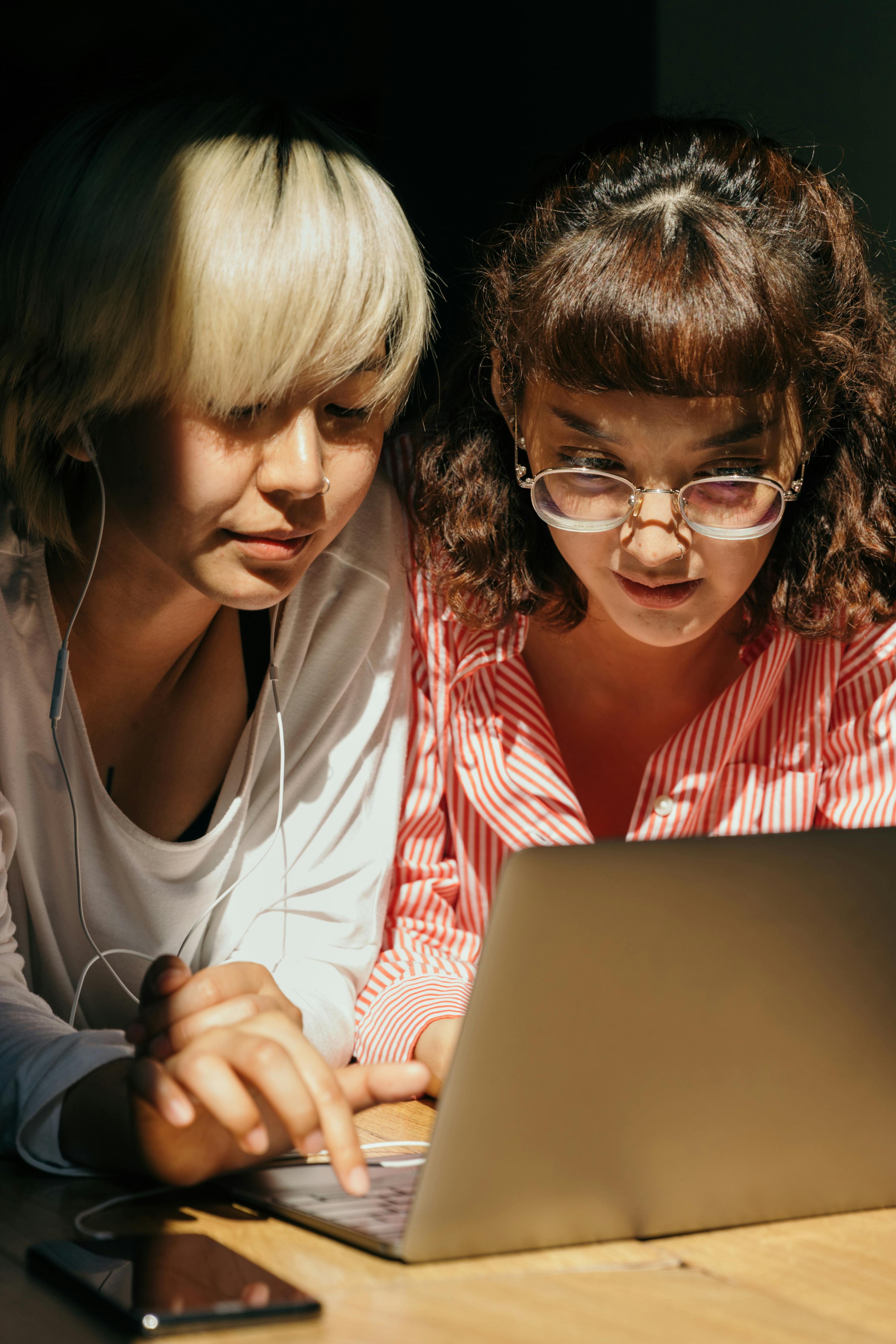 content girlfriends using laptop together