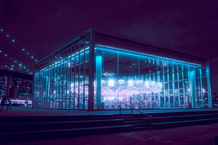 Glass Building With Carousel Glowing In Night