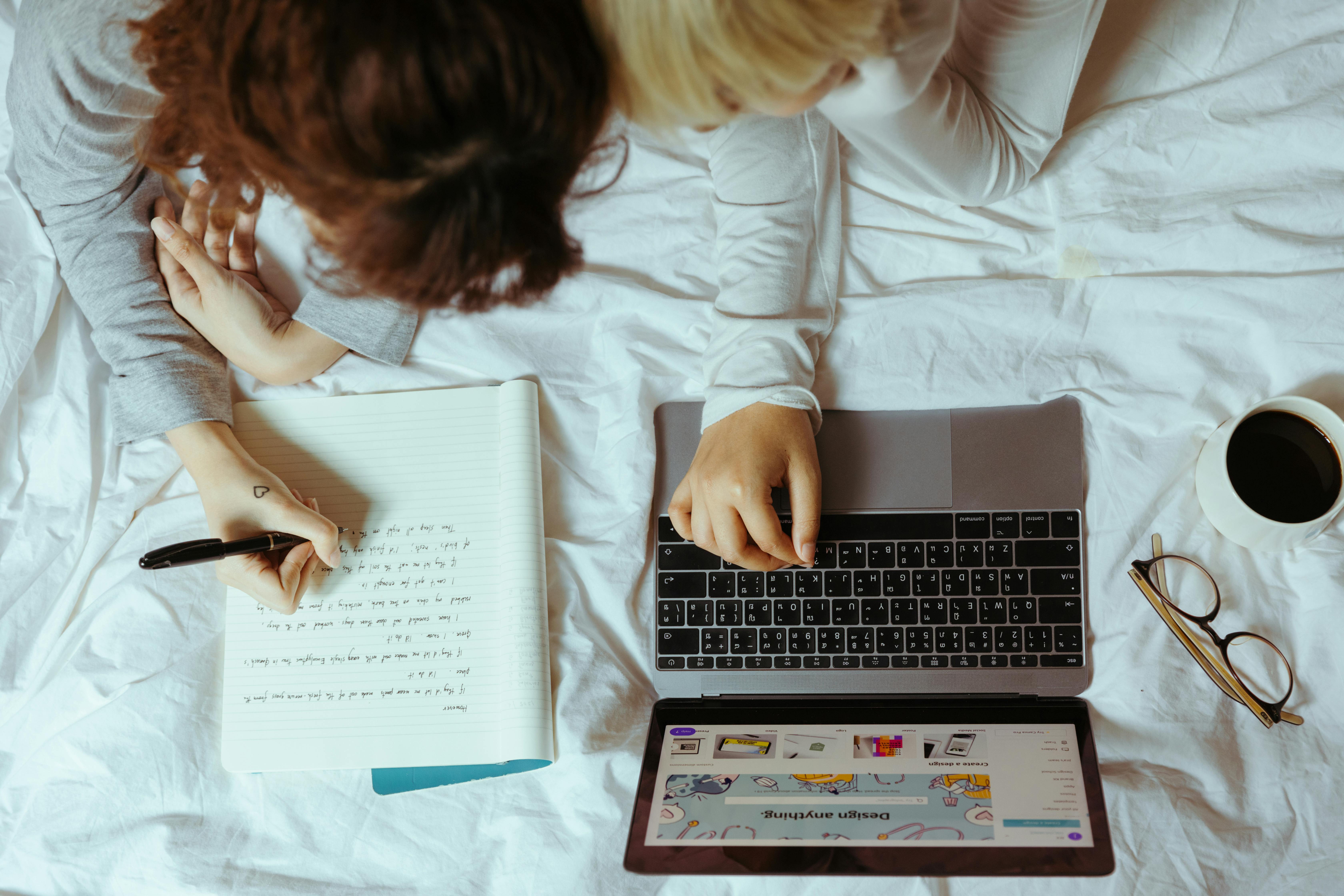 crop women using laptop in bedroom