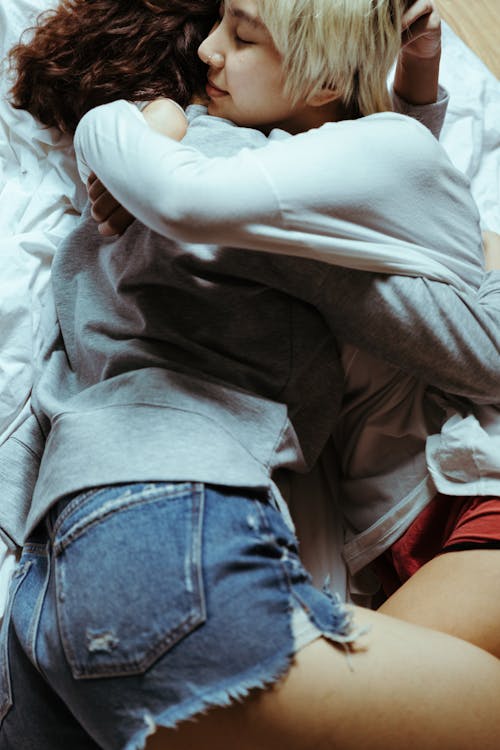 Women Hugging in Bed