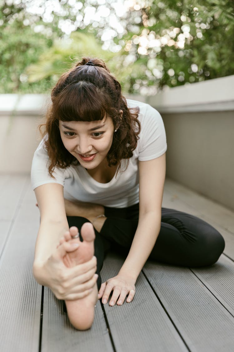 Young Happy Woman Stretching On Balcony