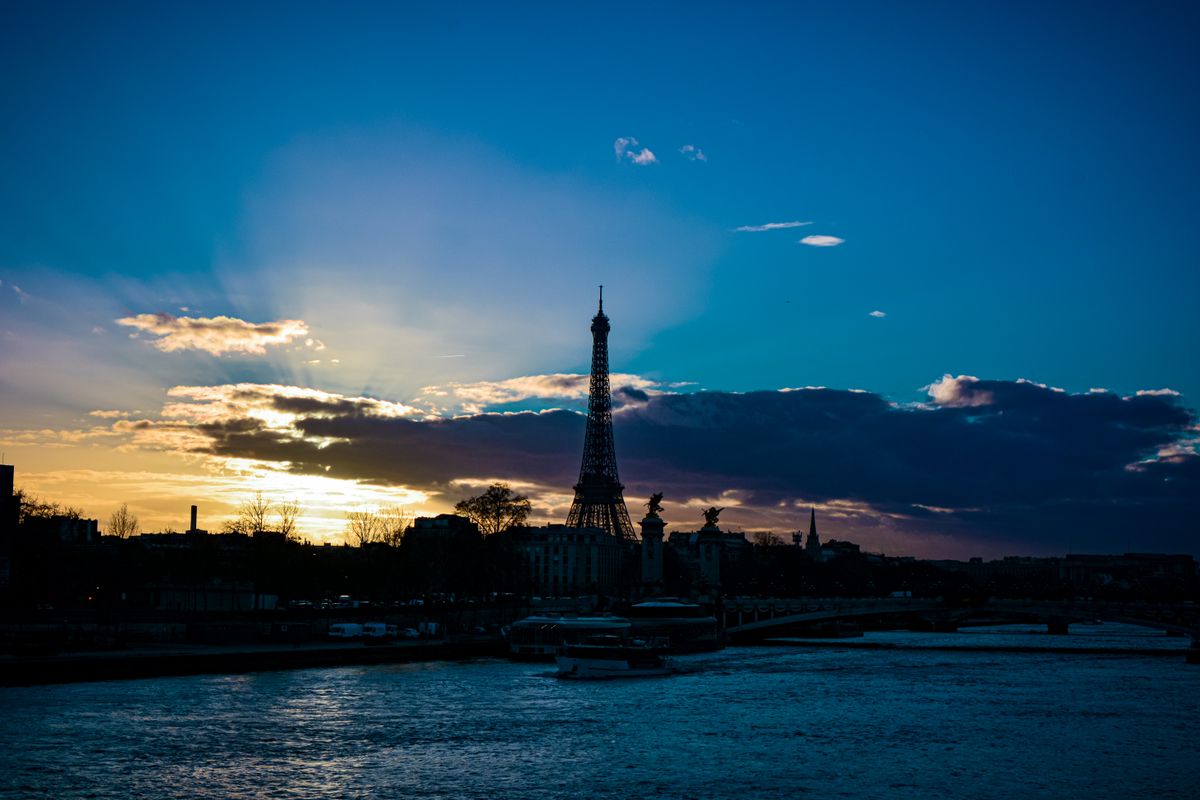 The Eiffel Tower sparkling above the Seine at sunset, the enduring symbol of Paris romance