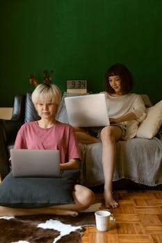 Casual scene of two women working remotely in a living room setting.