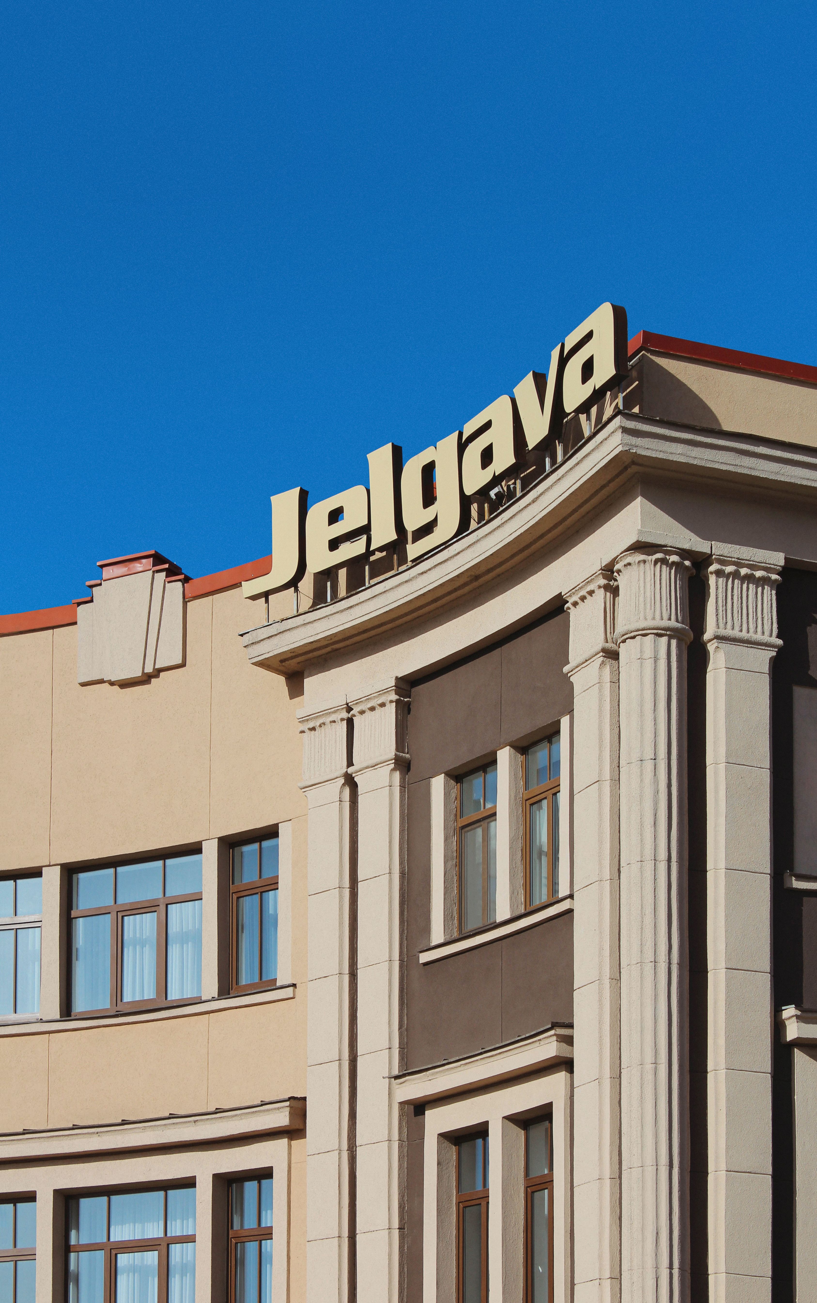 Elegant architectural facade in Jelgava, Latvia under clear blue skies.