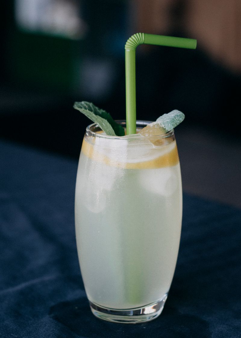 Icy lemonade in a clear glass with lemon slices and mint.