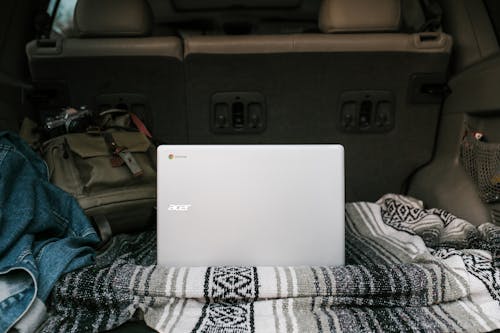 White Asus Laptop on Gray Car Seat