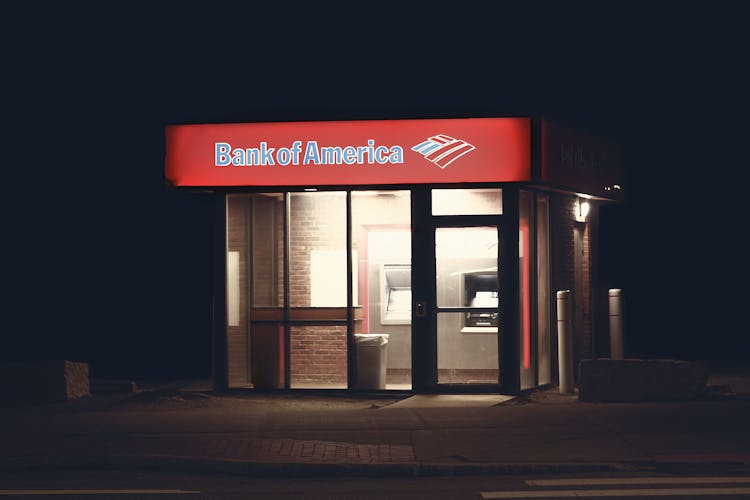 An ATM Machine On The Side Of The Road During Night Time