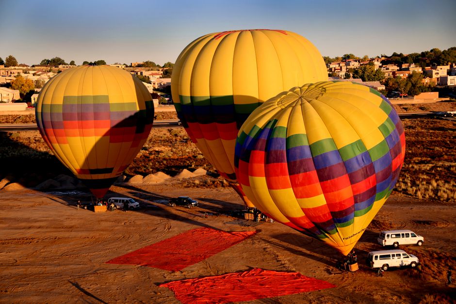 Vibrant hot air balloons preparing for flight at Albuquerque, capturing the festive atmosphere.