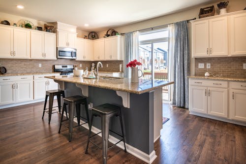 Brown Marbled Kitchen Counter and White Kitchen Cabinets