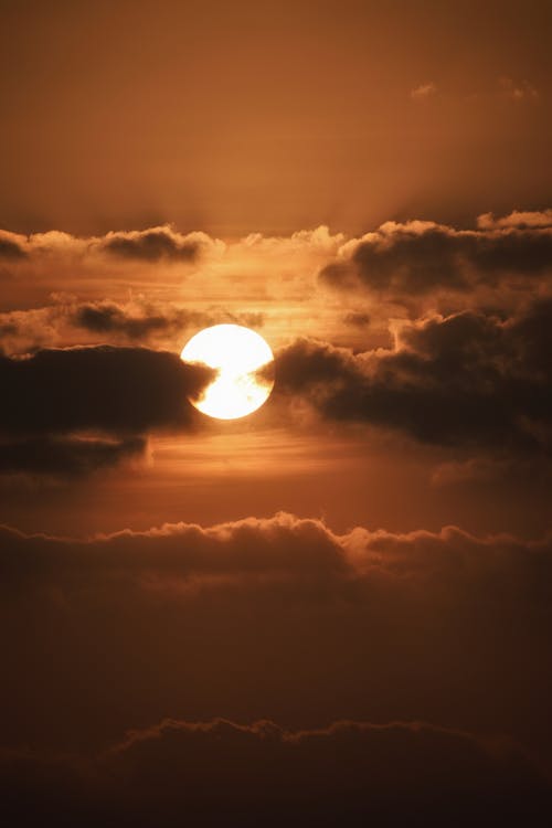 Dark clouds and sun over evening sky