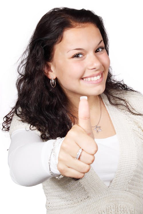 Free Smiling Woman Wearing White and Beige Showing Thumbs Up Stock Photo