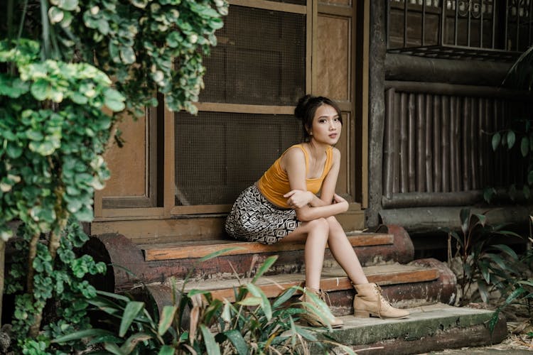 A Woman Sitting On Steps