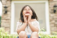 A Cute Girl Smiling without Teeth