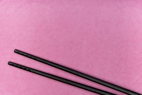 Black Metal Rod on Pink Textile