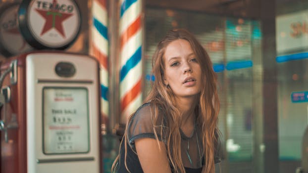 Portrait of a woman with long hair in a vintage setting featuring retro decor, conveying a relaxed and stylish vibe.