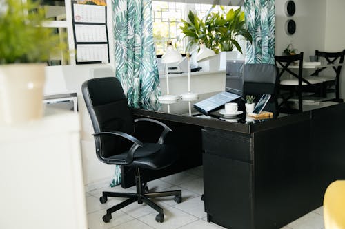 Free Interior of contemporary workplace with chair and laptop on table Stock Photo