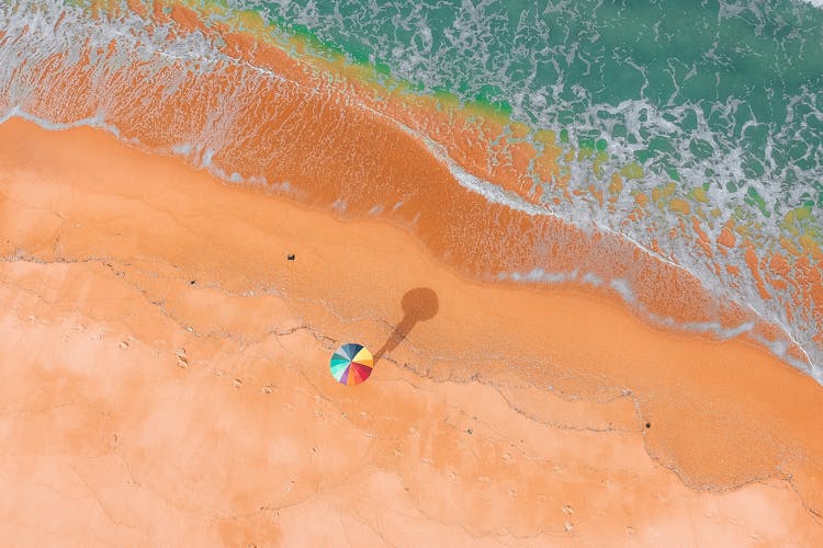 Aerial View Person With Colorful Umbrella On Beach