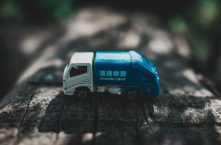 Toy Car On Wooden Surface In Park