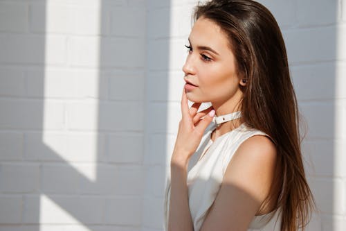 Free Woman in White Top Posing for Picture Stock Photo