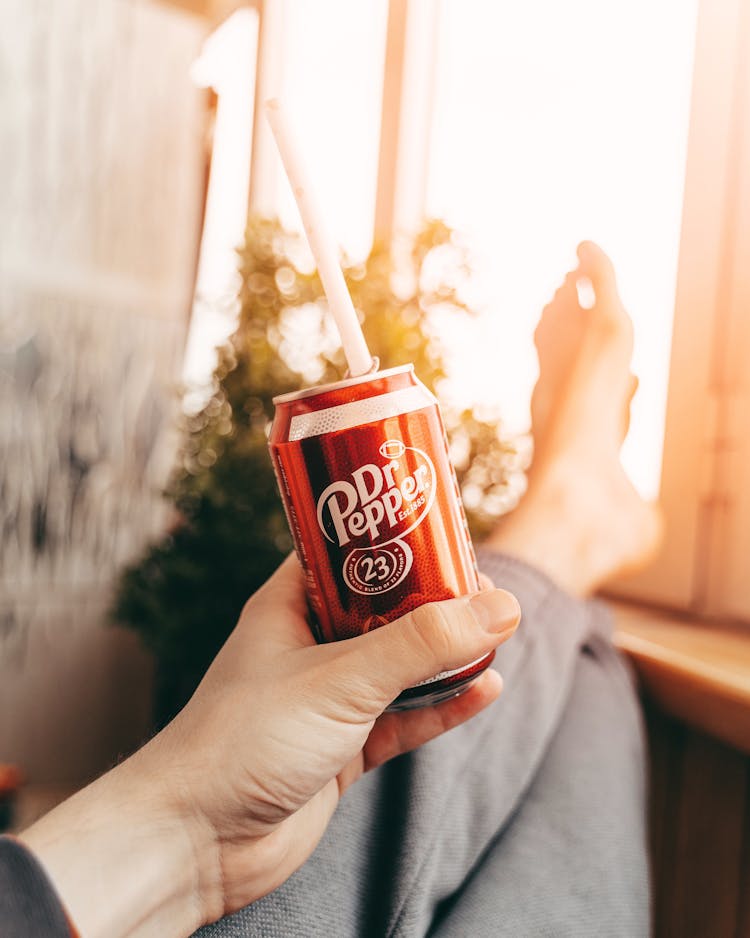 Crop Person Drinking Coke From Can While Resting At Home