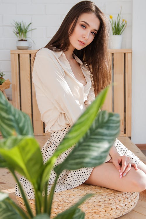 Free Woman Sitting on Brown Woven Chair Stock Photo