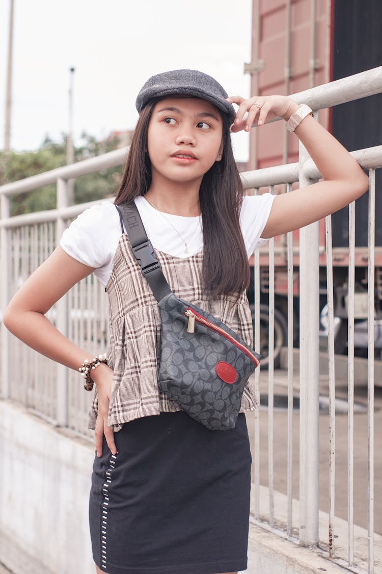 Trendy Ethnic Teen Standing Near Railing On Street