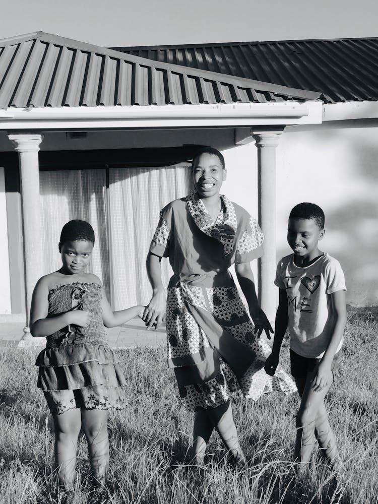 Cheerful Black Mother With Kids In Backyard