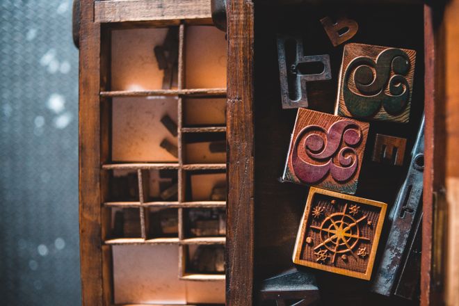 Wooden letterpress type in a printer's drawer — photo by Erik Mclean on Pexels