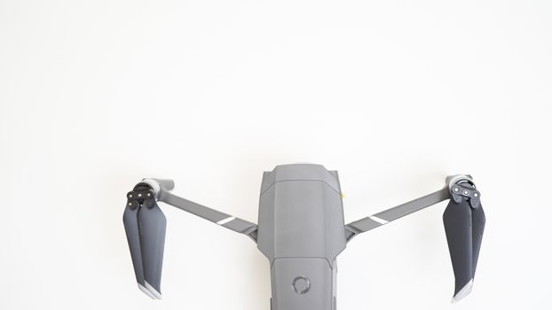 Top view of a high-tech drone on a minimal white background, showcasing modern technology.