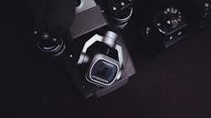 Modern photo camera on black surface