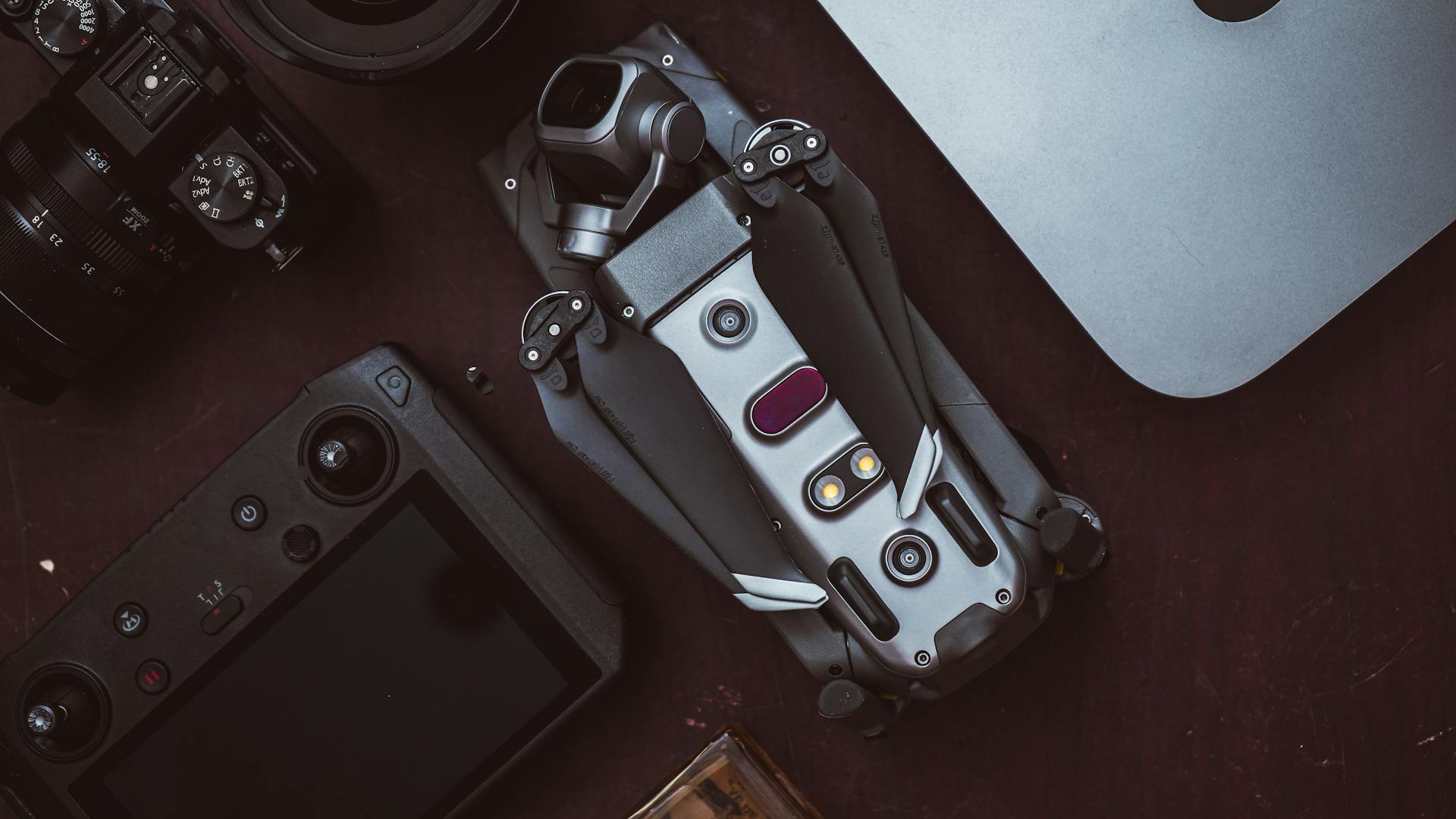 High-angle shot of drone and camera equipment on a table, ideal for tech enthusiasts.