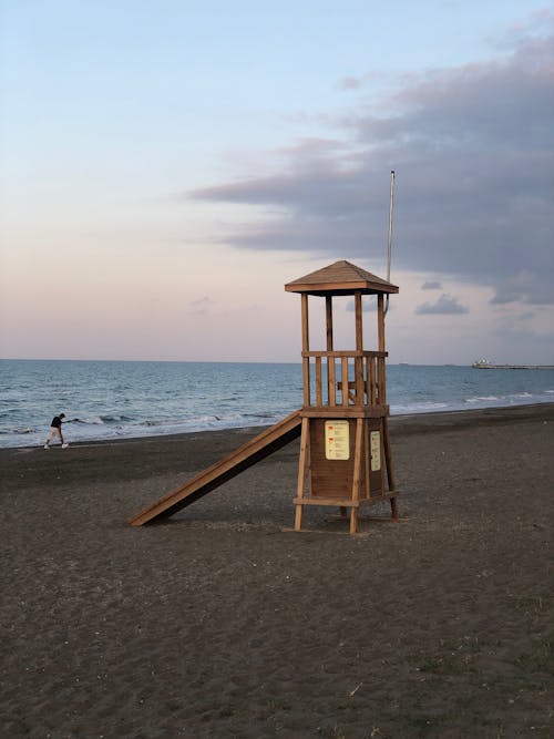 Cozy small wooden lifeguard station located on empty sandy beach in dusk
