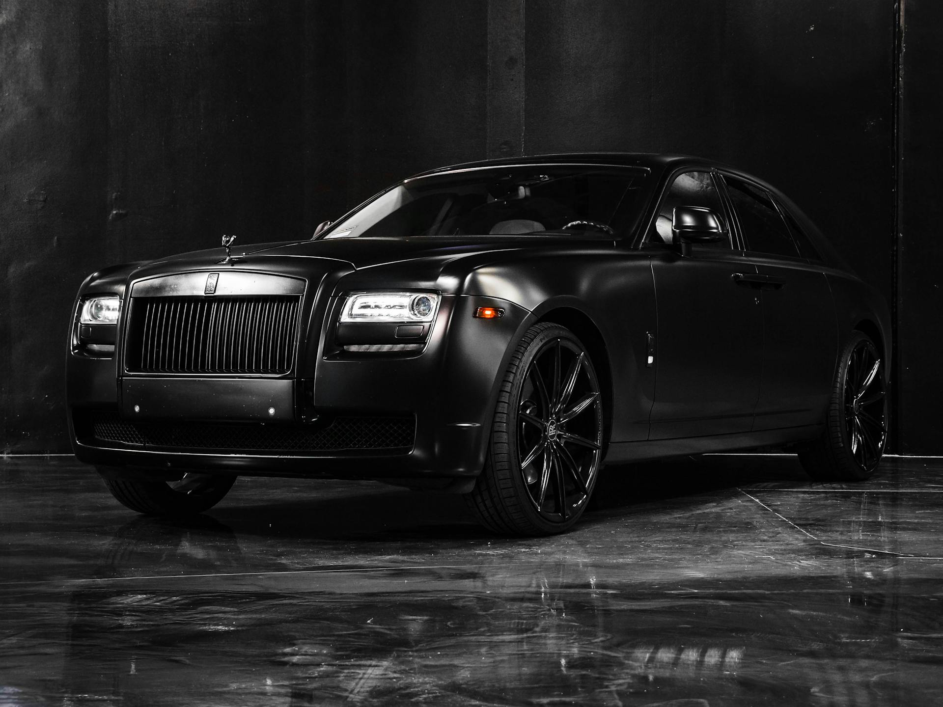 Expensive elegant fashioned new black car with headlights square parked on marble floor in showroom