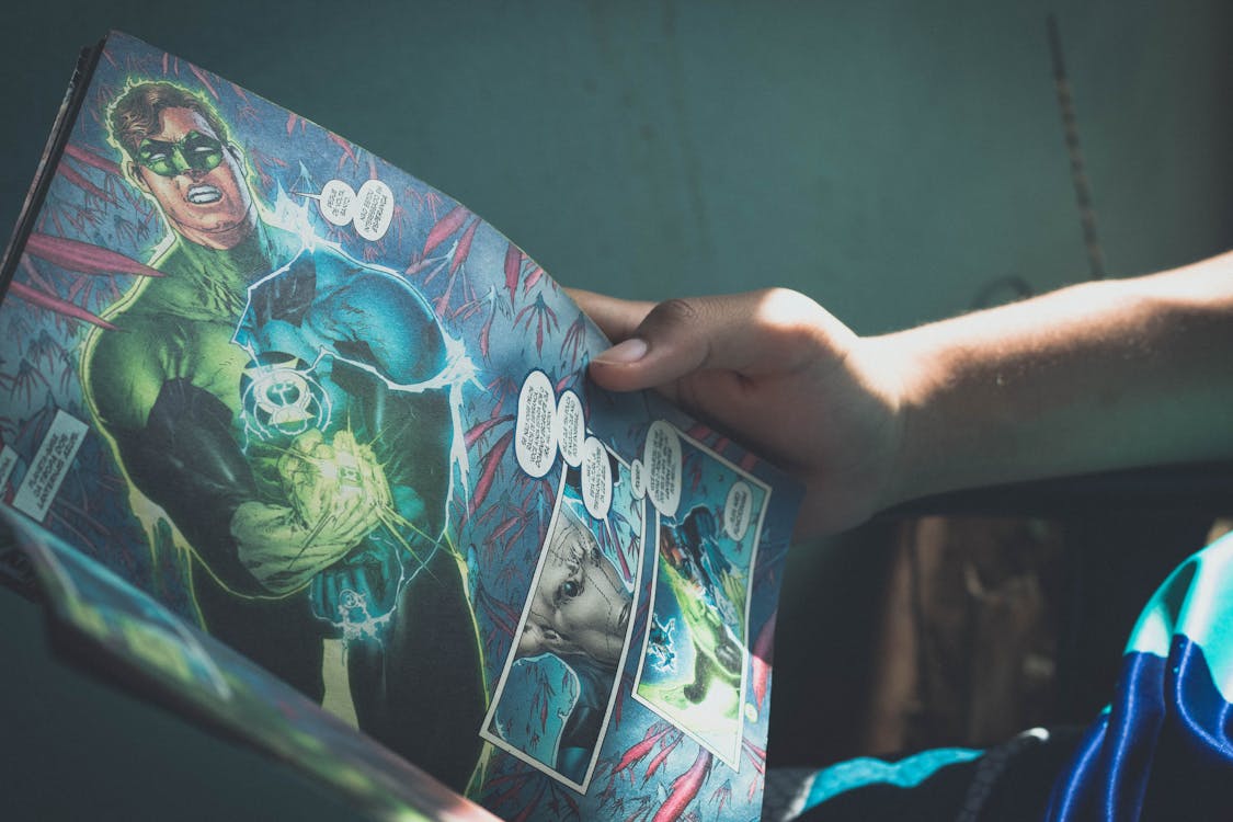 Free Crop person reading story about superhero Stock Photo