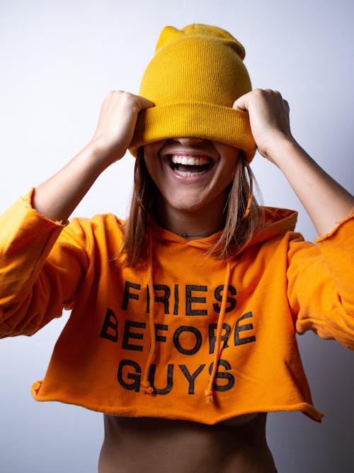 Free Cheerful Lady Covering Eyes With Beanie Stock Photo