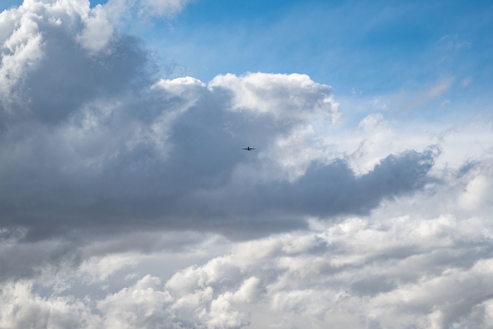 A private jet in flight above the clouds