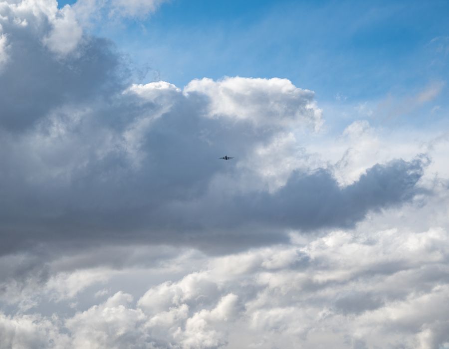 Airplane flying above clouds