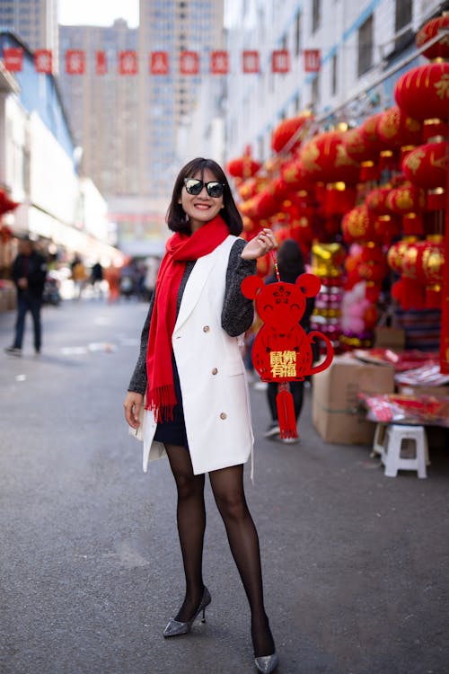 Free Cheerful young ethnic woman near outdoor souvenir shop Stock Photo