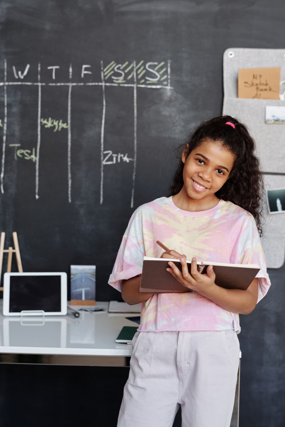 Teacher and student using a laptop together for online learning