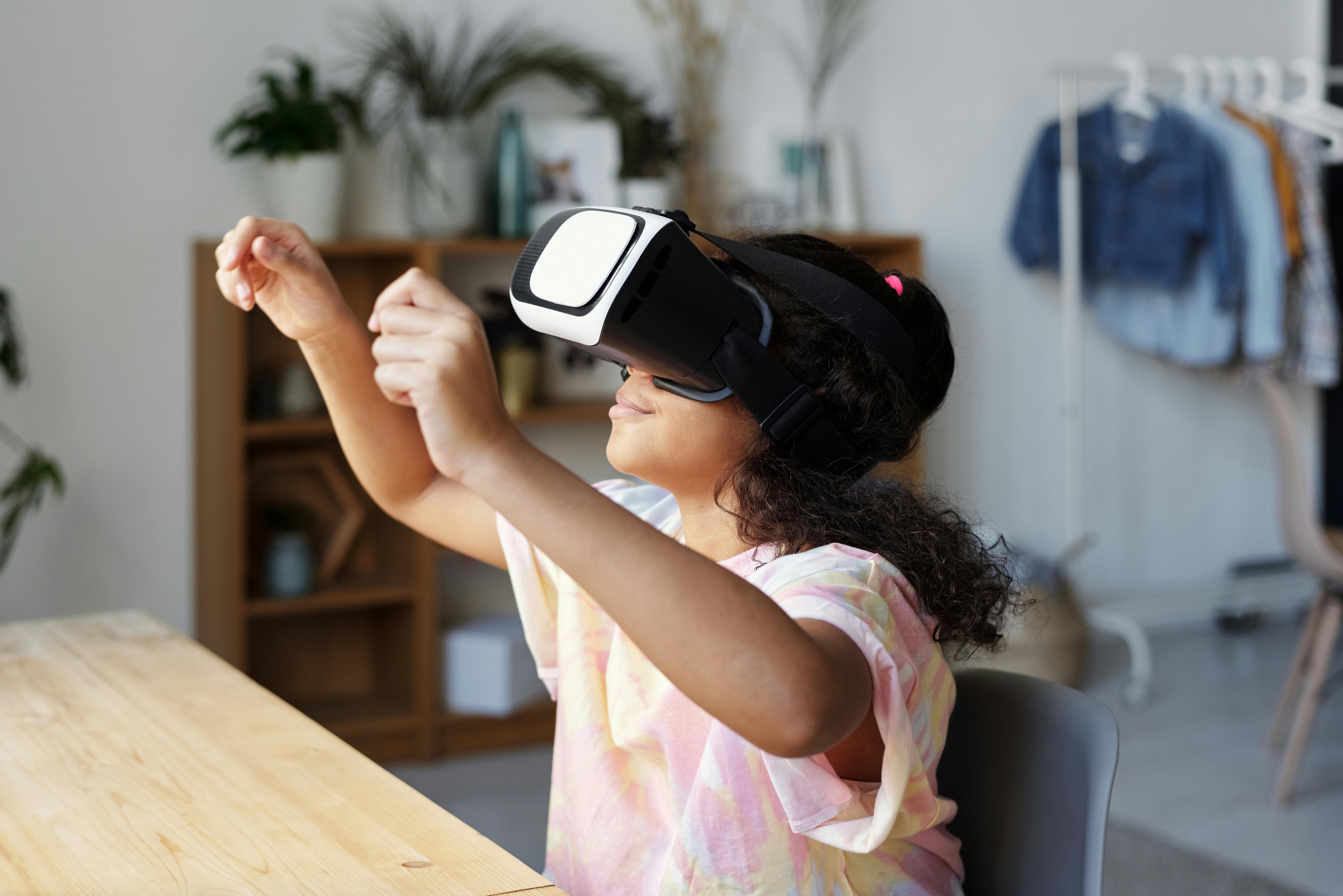 girl in pink shirt wearing black and white vr headset