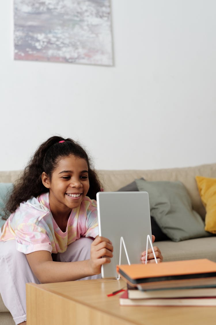 Photo Of Girl Smiling While Holding Tablet Computer